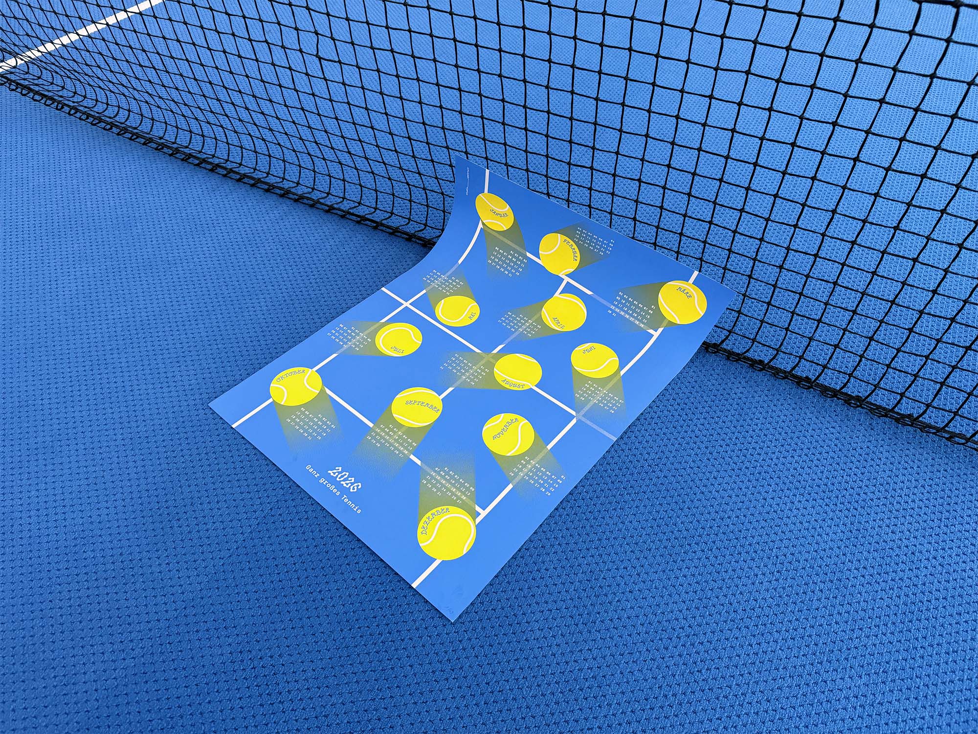 Photo of the 2026 studio_upstruct calendar leaning against a tennis net.